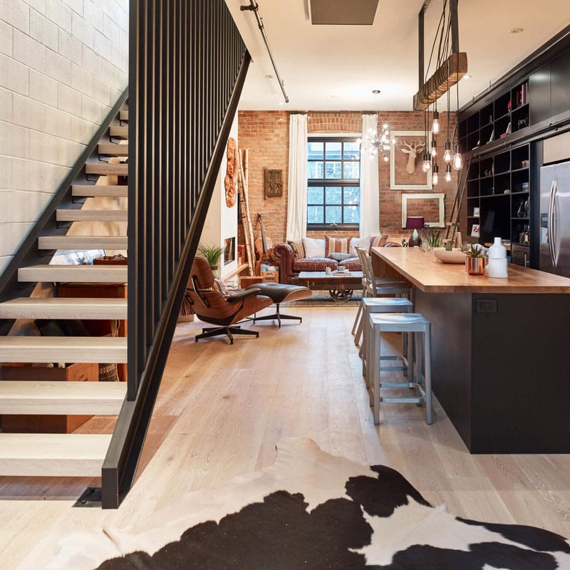reVISION Sugar Coated Custom renovation Kitchen and Living- black cabinets and large island - brick walls