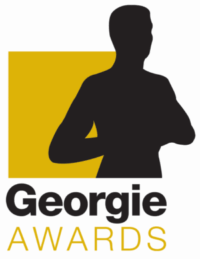 Silhouette of a woman with crossed arms in front of a gold square background for the Georgie Awards, celebrating excellence in community development and housing innovation.