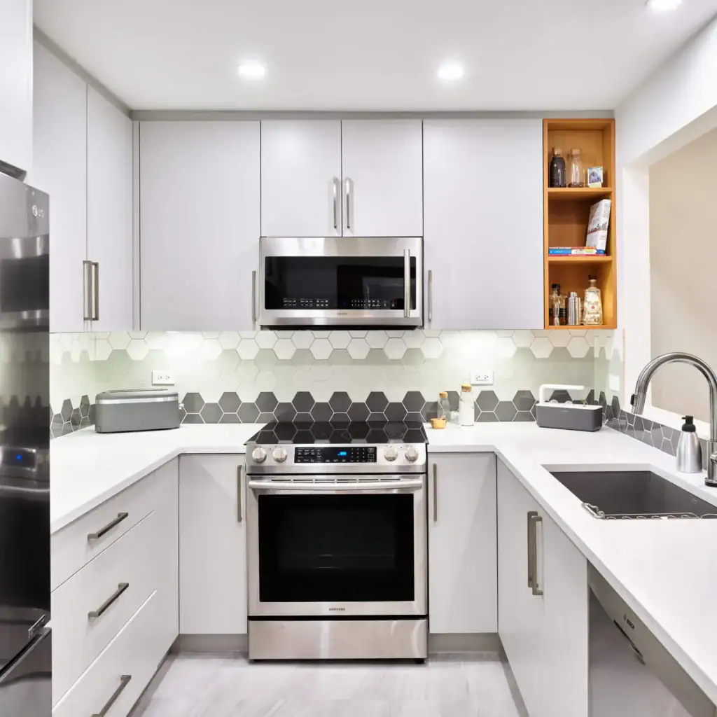 Modern white kitchen with stainless steel appliances, hexagonal backsplash, and minimalist cabinetry for stylish home cooking.